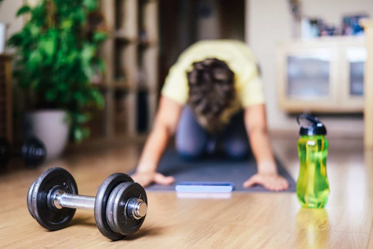 Woman At Home Doing Sports Training Stretching In Early Morning.